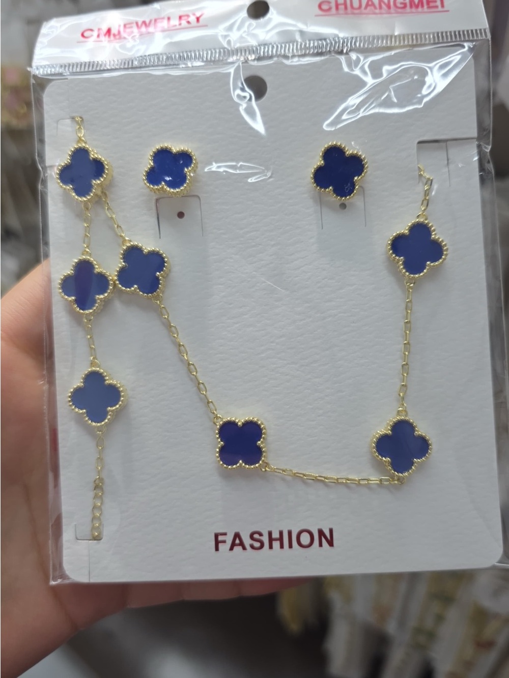 Ping Gold-Tone Necklace with Blue Clover Charms and Matching Studs